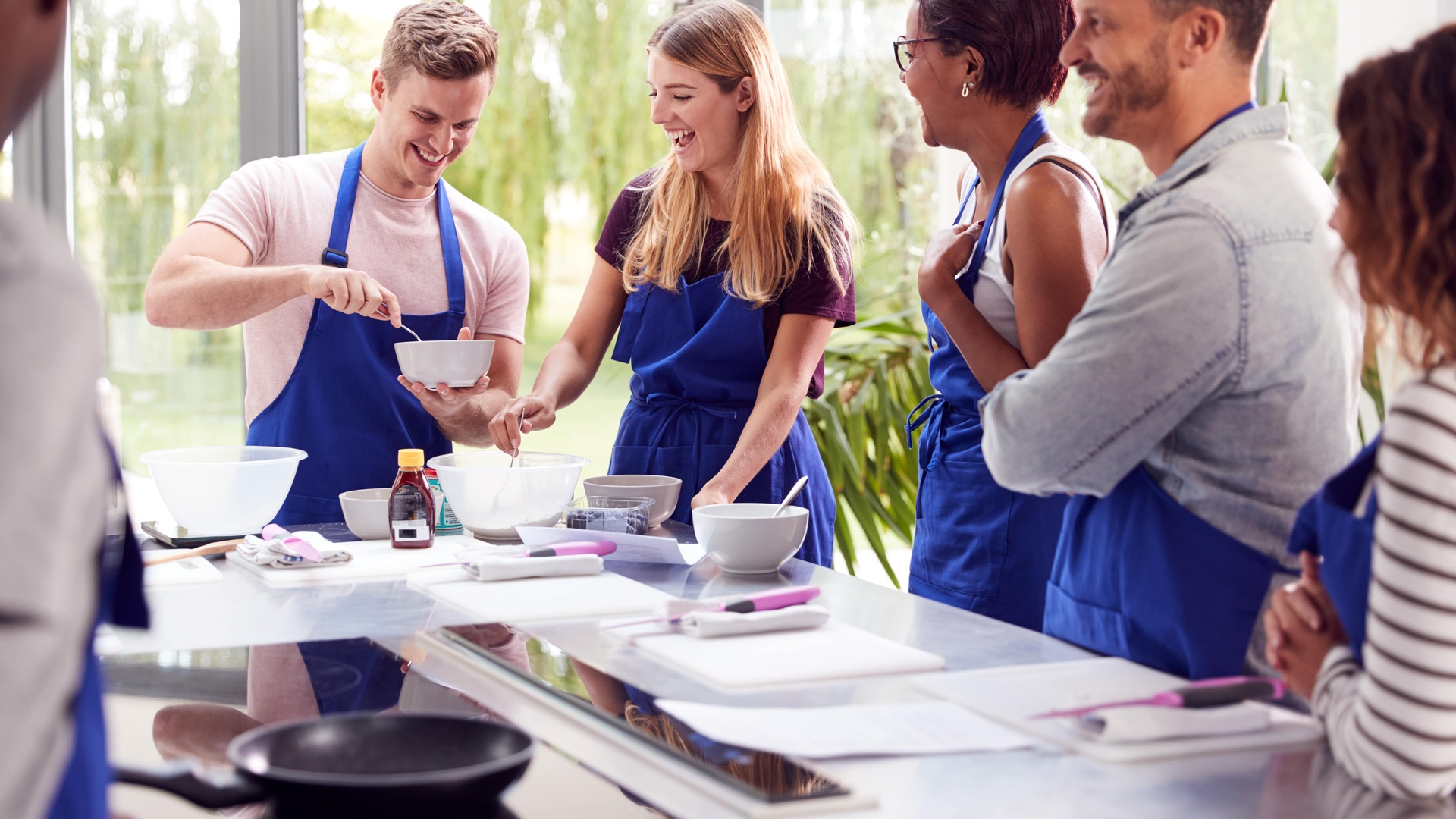 Community cooking together in bright kitchen